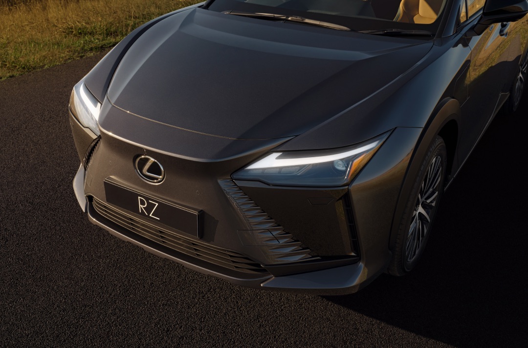 Aerial view of the front Lexus RZ grille, with headlights on.