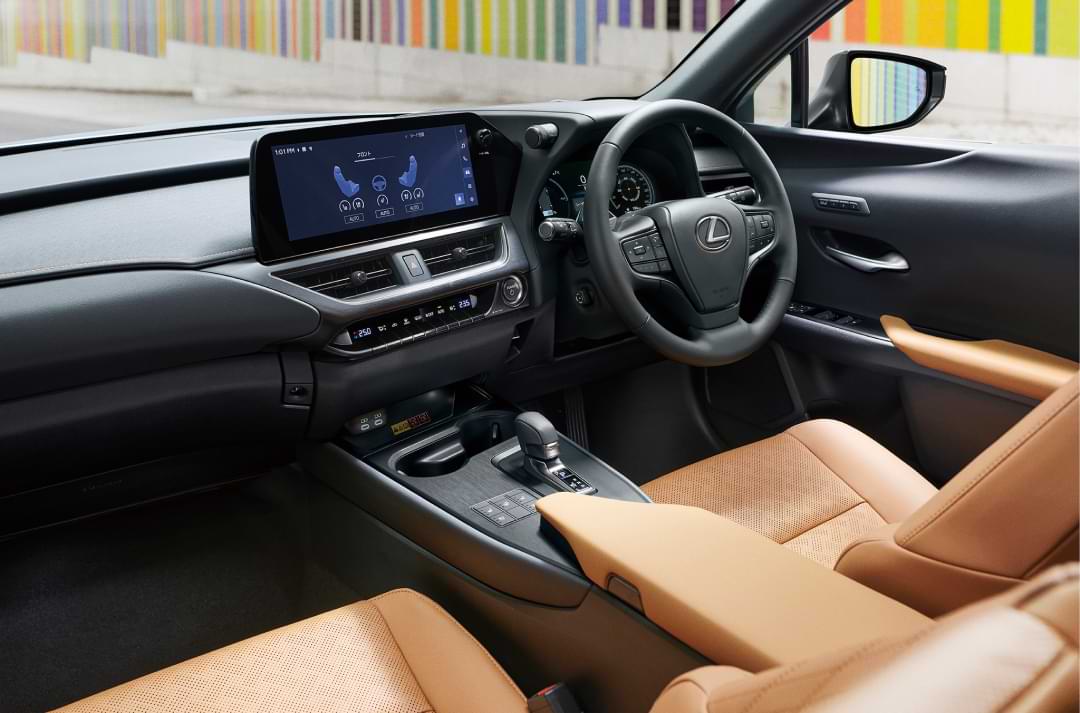 Interior of a car, focusing on the drivers seat, steering wheel and dashboard.