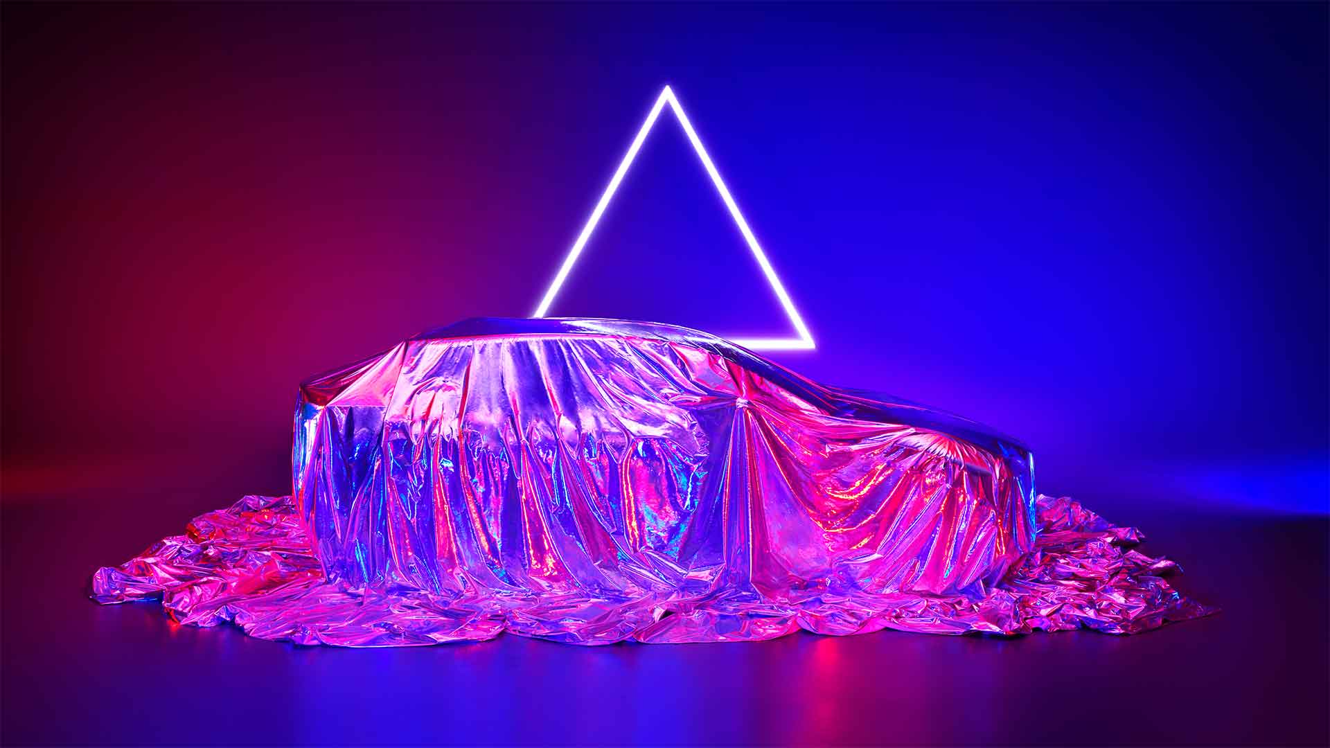 A new Lexus vehicle shrouded in a silver material cover