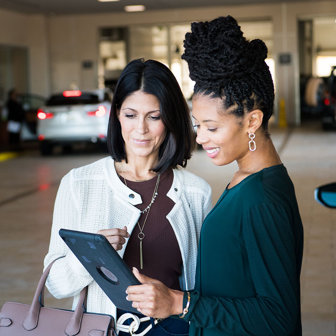 Two women look at a tablet together
